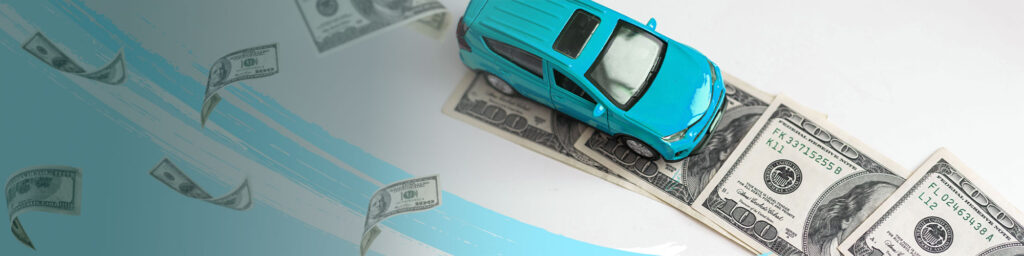 Dollar bills floating in air with toy car resting on dollar bills.